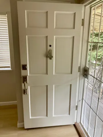 wooden floor in an empty room with a window