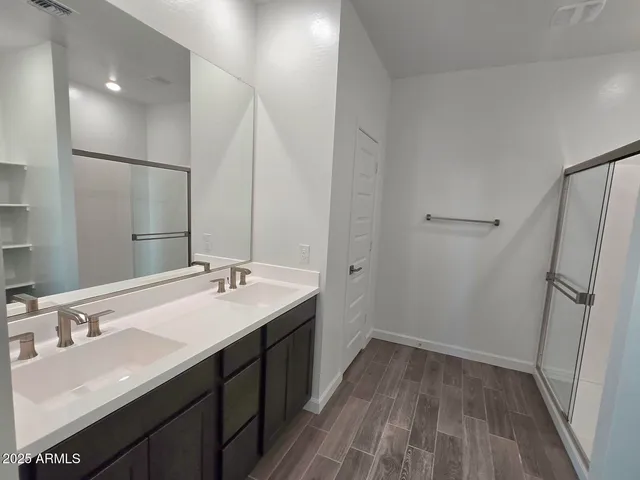 a bathroom with a double vanity sink and a mirror