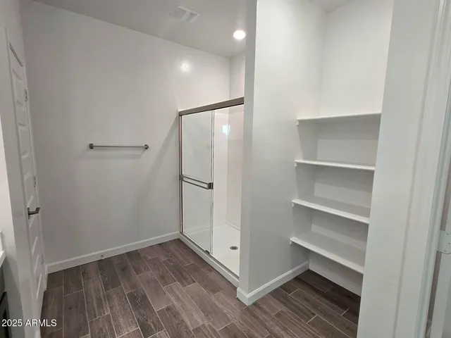 a room with a closet and a potted plant