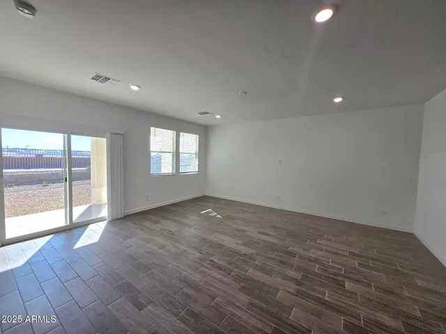 a living room with furniture a flat screen tv and a large window