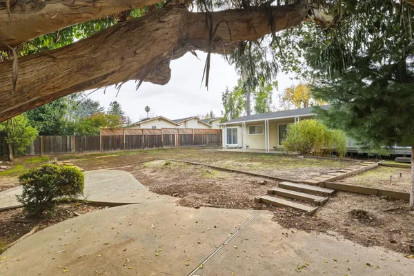 a view of a white house with a yard