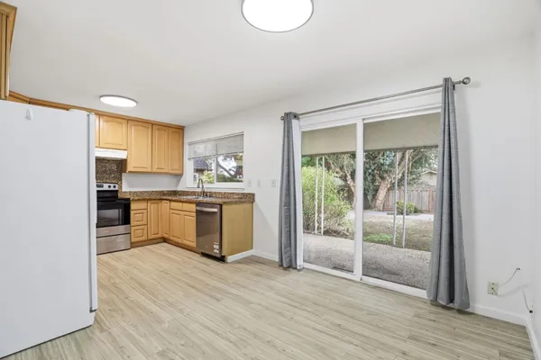 a kitchen with a refrigerator and a sink