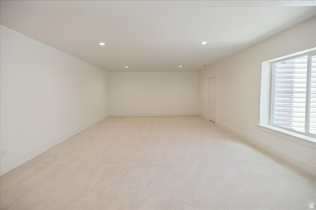 952 Mathilda Drive, Unit 156 Saratoga Springs, UT 84045 - Photo 20 of 25 Spacious room featuring neutral carpeting, recessed lighting, white walls, and a large window with white louvered blinds