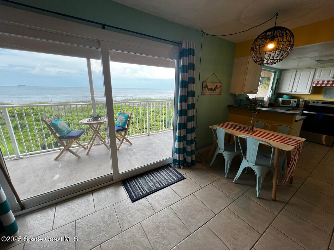 3150 North Atlantic Avenue, Unit 11550 Cocoa Beach, FL 32931 - Photo 11 of 30 a room with chairs a table and chairs