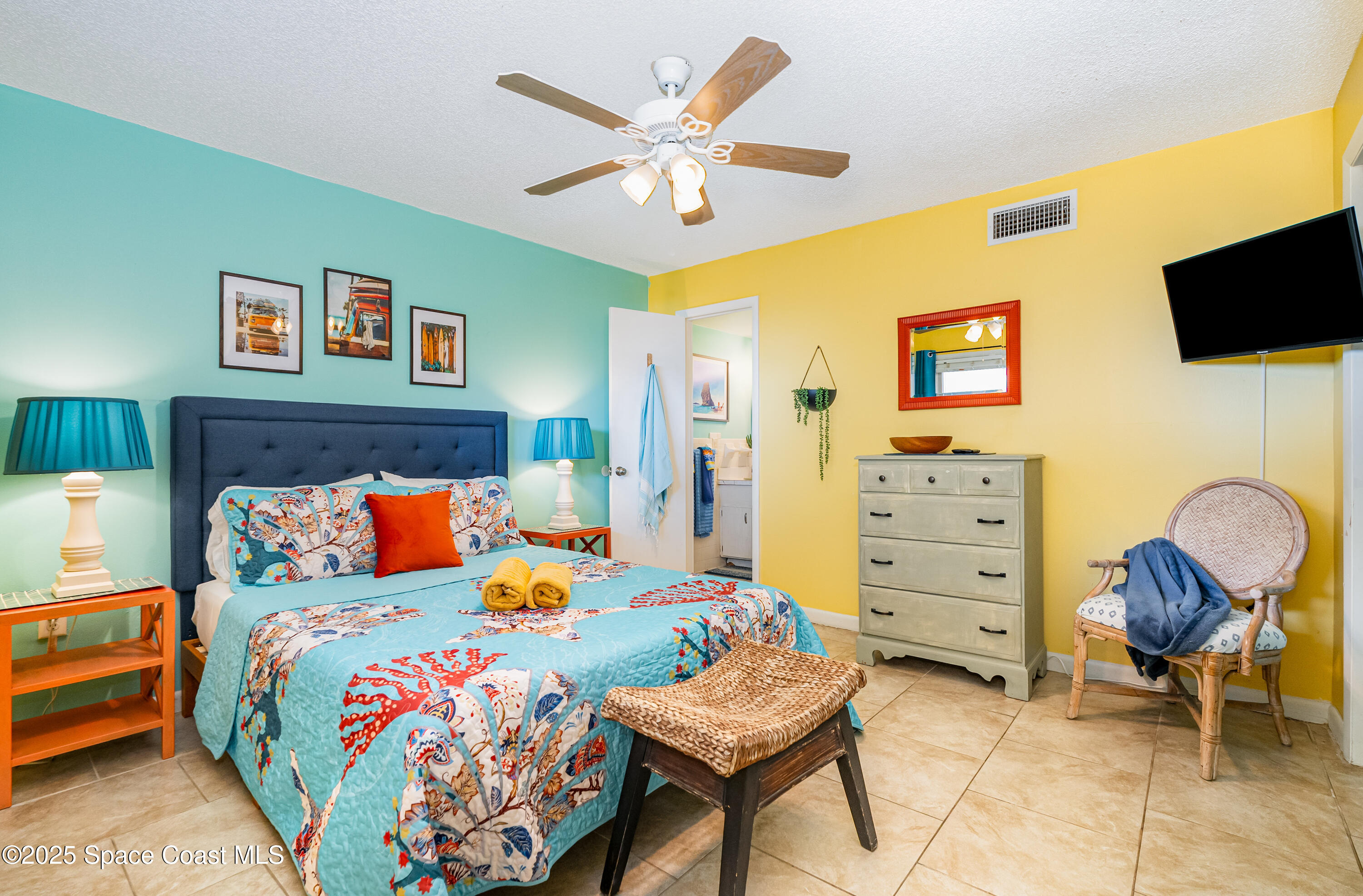 3150 North Atlantic Avenue, Unit 11550 Cocoa Beach, FL 32931 - Photo 12 of 30 a bedroom with a bed and ceiling fan