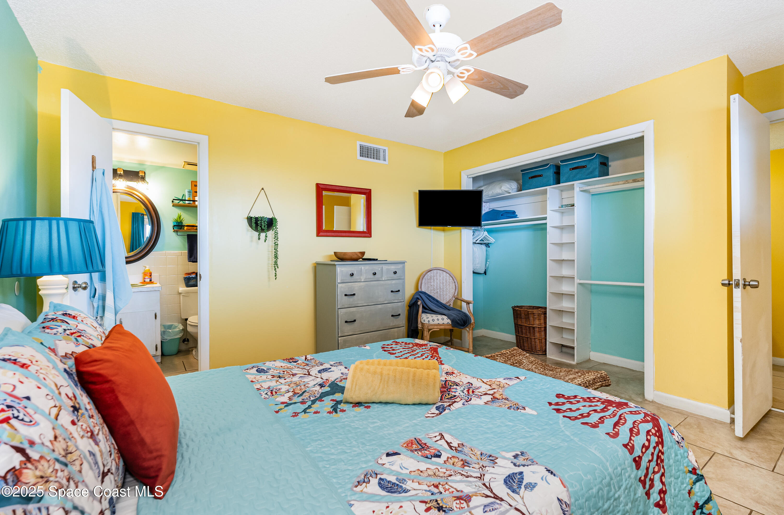 3150 North Atlantic Avenue, Unit 11550 Cocoa Beach, FL 32931 - Photo 13 of 30 a bedroom with a bed dresser and a window