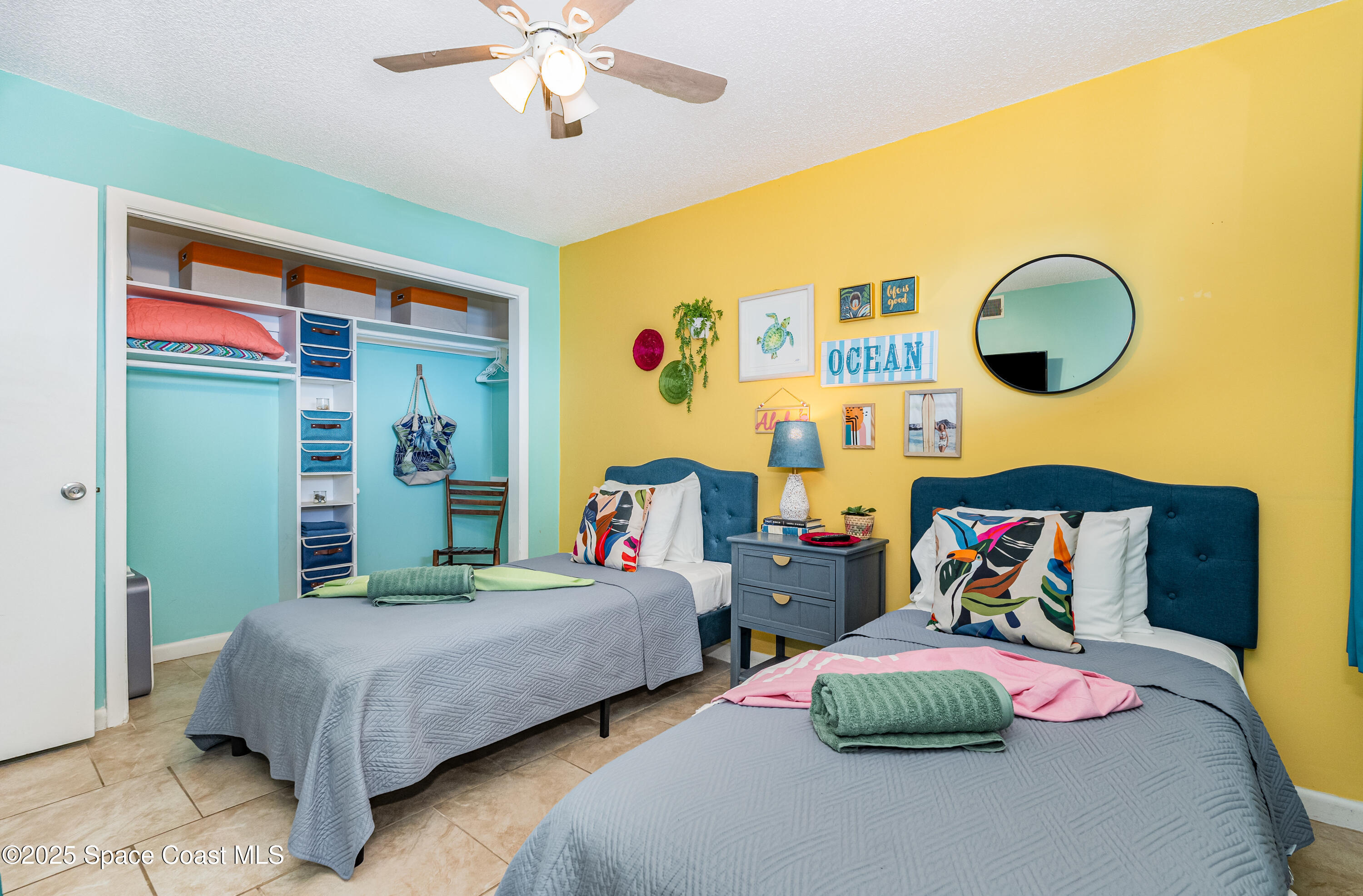 3150 North Atlantic Avenue, Unit 11550 Cocoa Beach, FL 32931 - Photo 15 of 30 a bedroom with 2 bed and a painting on the wall