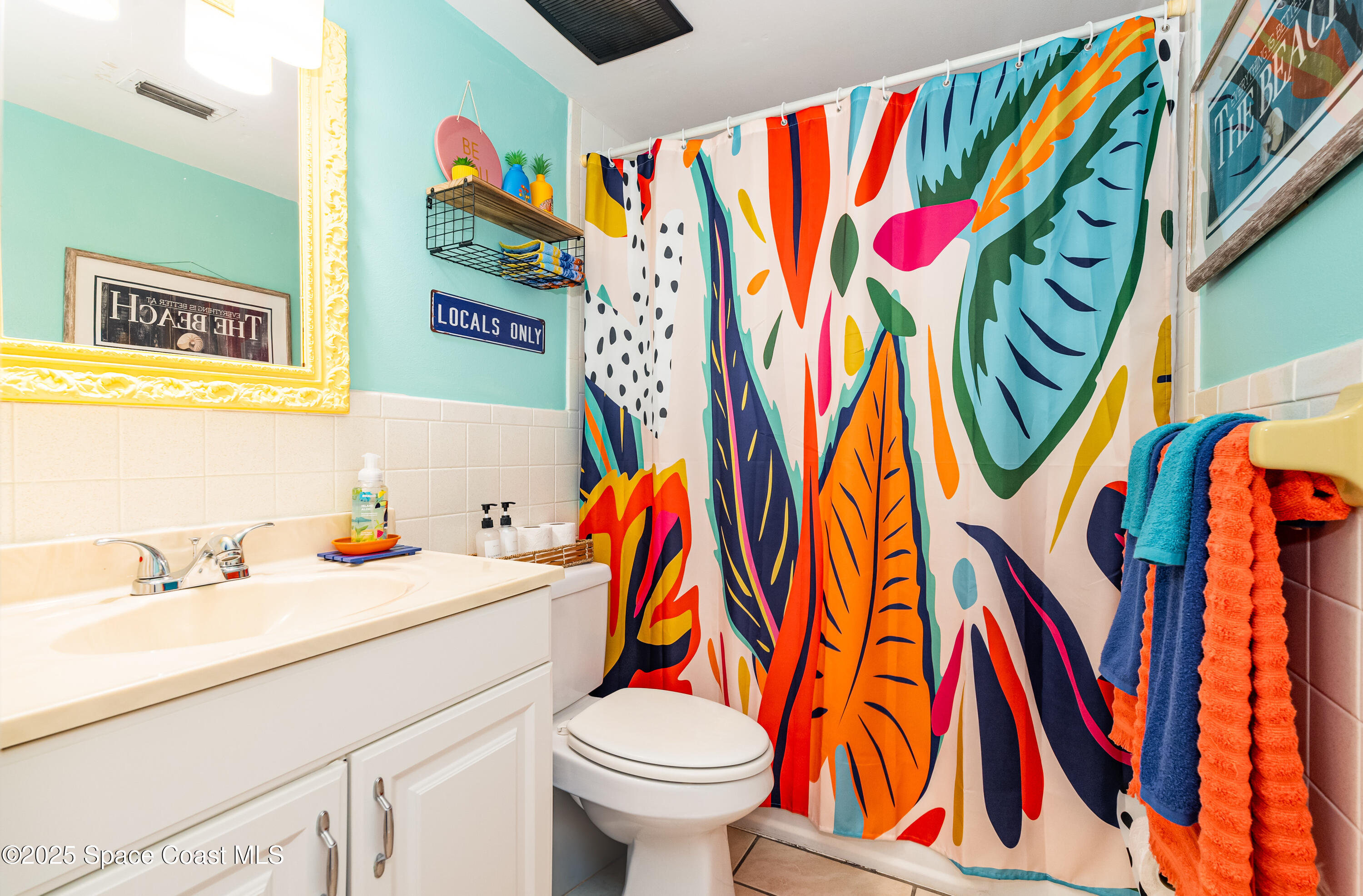 3150 North Atlantic Avenue, Unit 11550 Cocoa Beach, FL 32931 - Photo 17 of 30 a bathroom with a sink and a mirror