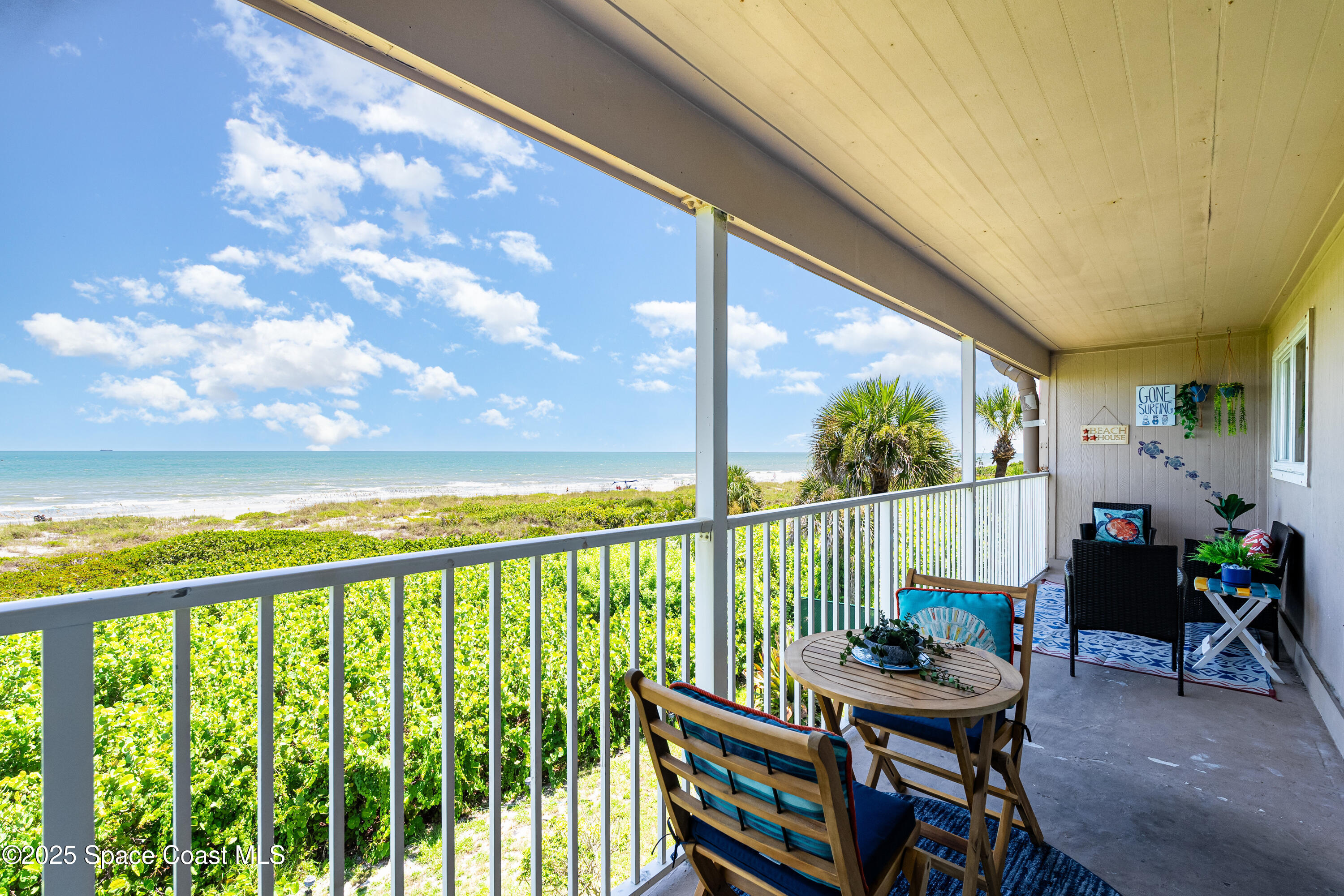 3150 North Atlantic Avenue, Unit 11550 Cocoa Beach, FL 32931 - Photo 20 of 30 a view of a balcony with chairs and a table