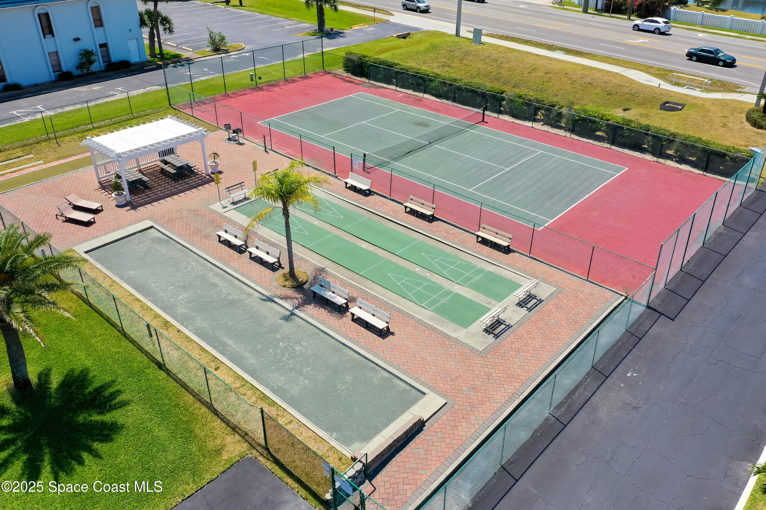 3150 North Atlantic Avenue, Unit 11550 Cocoa Beach, FL 32931 - Photo 26 of 30 a view of a tennis ground with large trees