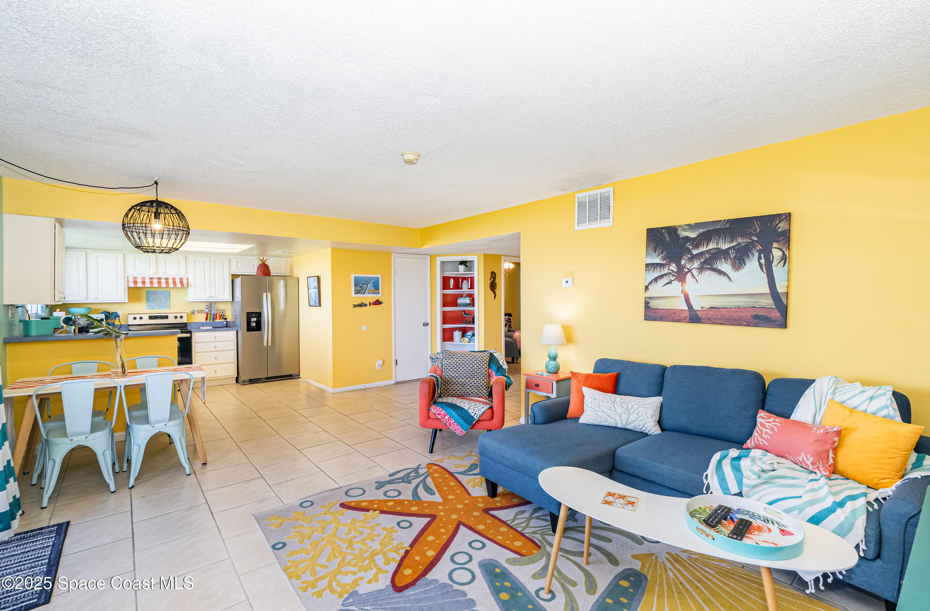 3150 North Atlantic Avenue, Unit 11550 Cocoa Beach, FL 32931 - Photo 7 of 30 a living room with furniture and a large window