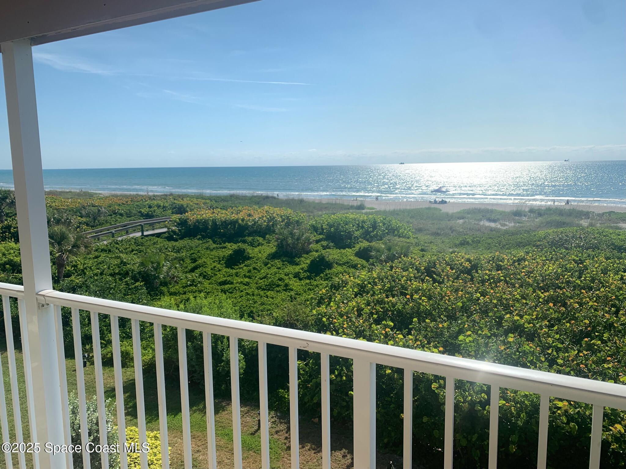3150 North Atlantic Avenue, Unit 11550 Cocoa Beach, FL 32931 - Photo 9 of 30 a view of a green field with two buildings in background
