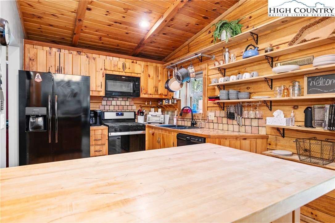 375 Winterberry Trail Boone, NC 28607 - Photo 12 of 36 a kitchen with stainless steel appliances kitchen island granite countertop a refrigerator and a wooden cabinets