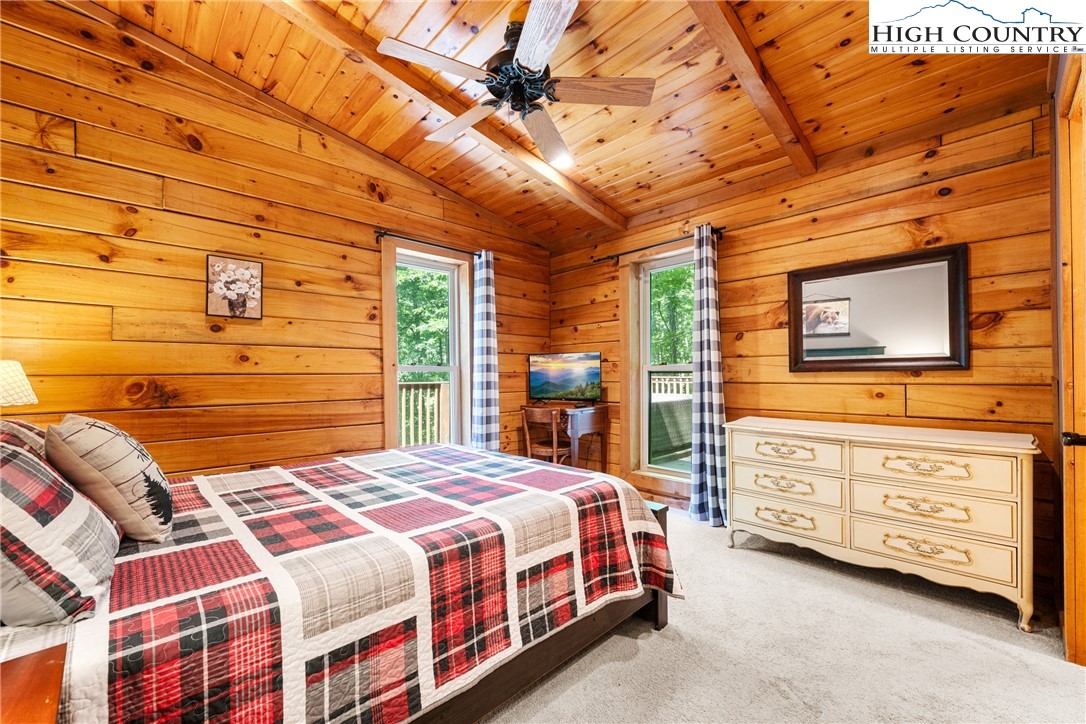 375 Winterberry Trail Boone, NC 28607 - Photo 13 of 36 a bedroom with a bed a dresser next to a window