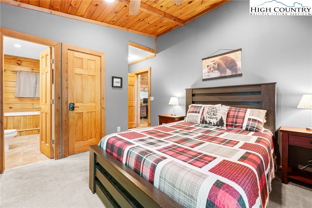 375 Winterberry Trail Boone, NC 28607 - Photo 14 of 36 a bedroom with a bed and a painting on the wall