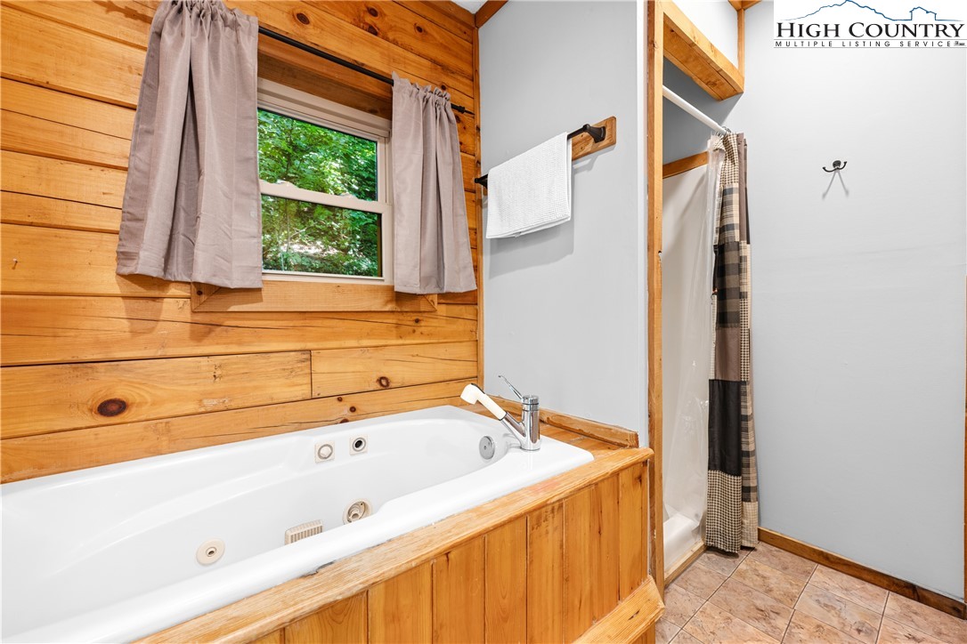 375 Winterberry Trail Boone, NC 28607 - Photo 15 of 36 a bathroom with a bathtub and shower