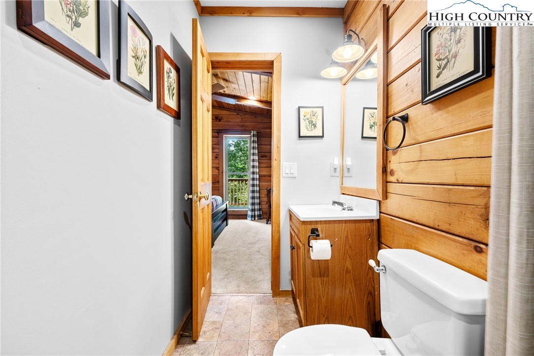 375 Winterberry Trail Boone, NC 28607 - Photo 16 of 36 a bathroom with a granite countertop toilet sink and mirror