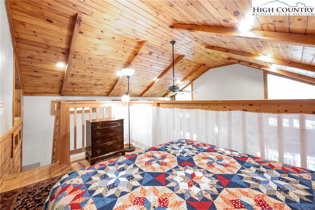 375 Winterberry Trail Boone, NC 28607 - Photo 19 of 36 a bedroom with a bed and wooden floor