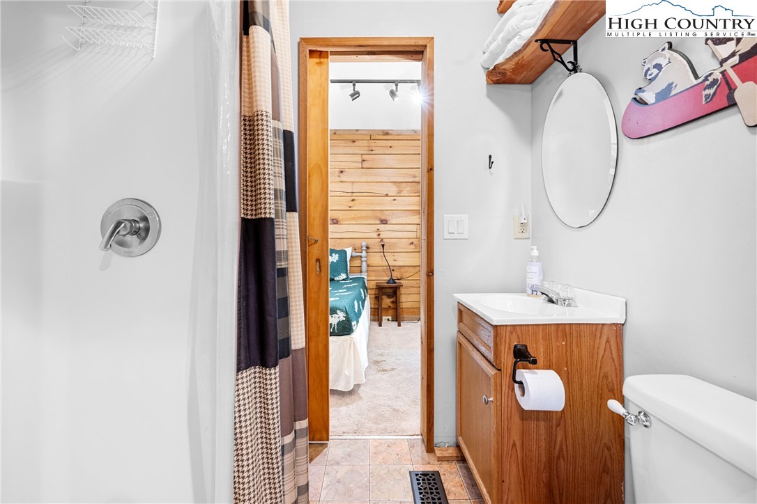 375 Winterberry Trail Boone, NC 28607 - Photo 21 of 36 a bathroom with a toilet sink and mirror