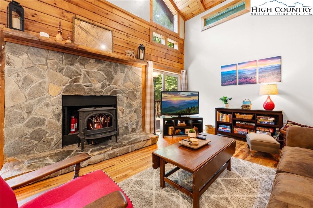 375 Winterberry Trail Boone, NC 28607 - Photo 5 of 36 a living room with furniture a flat screen tv and a fireplace