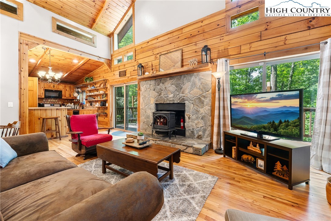 375 Winterberry Trail Boone, NC 28607 - Photo 6 of 36 a living room with furniture a flat screen tv and a fireplace