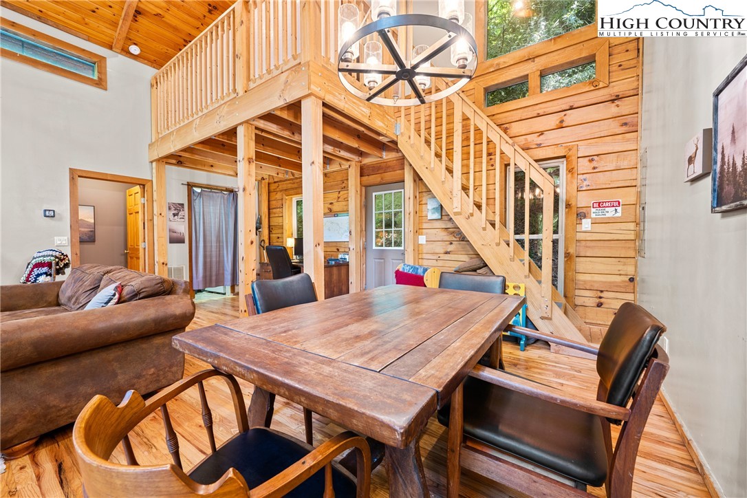 375 Winterberry Trail Boone, NC 28607 - Photo 7 of 36 a view of a dining room with furniture wooden floor and a chandelier