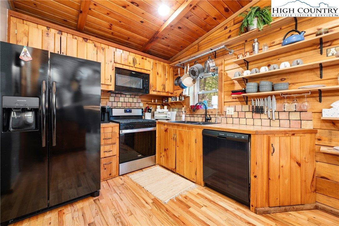 375 Winterberry Trail Boone, NC 28607 - Photo 10 of 36 a kitchen with stainless steel appliances kitchen island granite countertop a refrigerator and a stove top oven