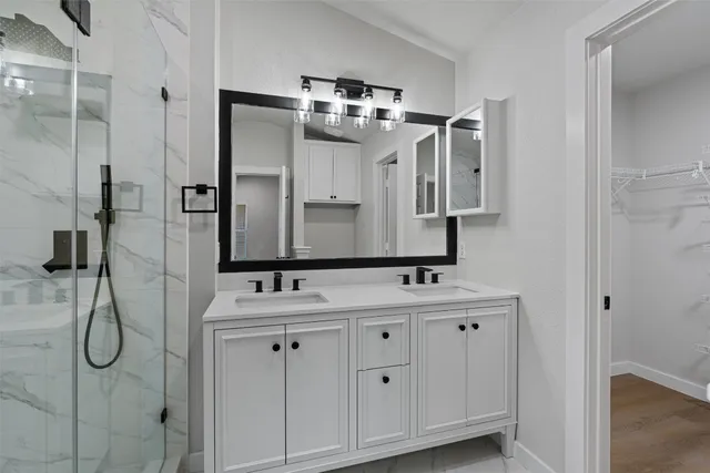 a bathroom with a double vanity sink mirror and