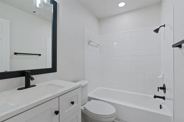 a bathroom with a sink a toilet a bathtub and shower