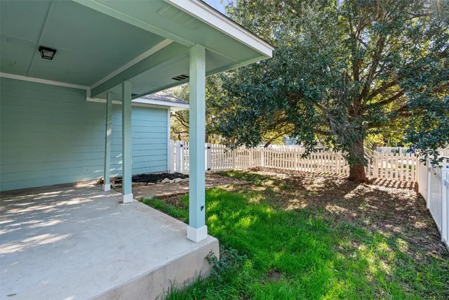 a backyard of a house with table and chairs