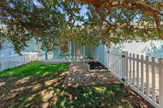 a view of a yard with large trees