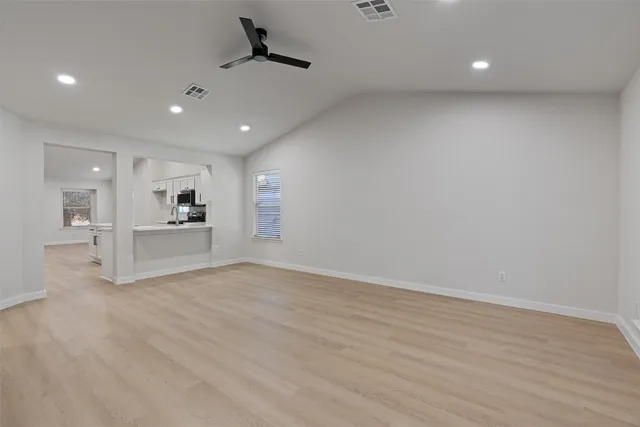 a view of a kitchen with a sink and a refrigerator