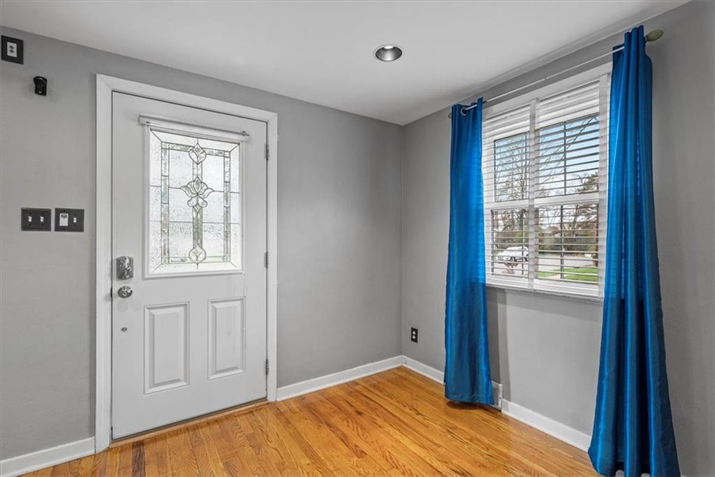 200 Hartle Road Glenshaw, PA 15116 - Photo 2 of 24 a view of an empty room with wooden floor and a window