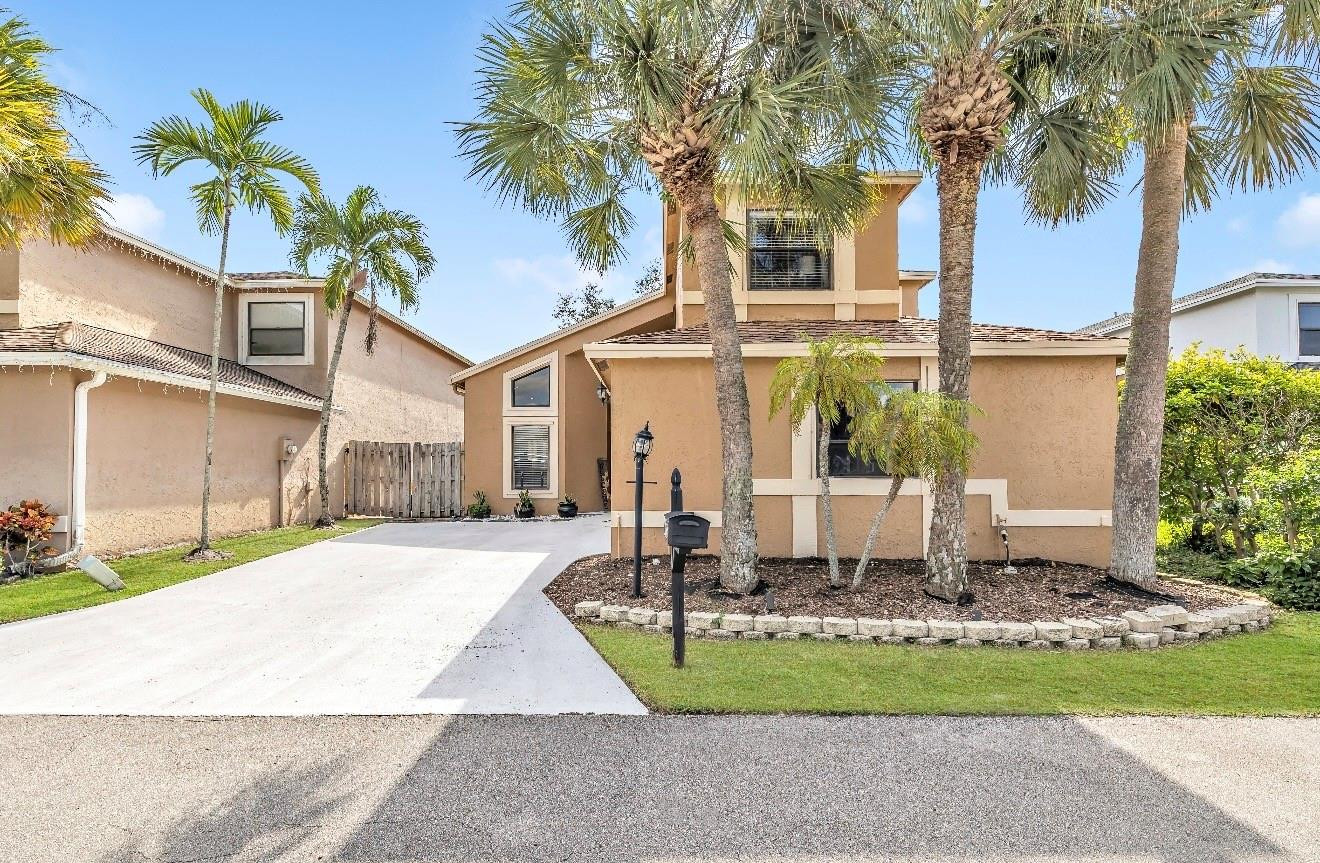 a front view of house with a garden and patio
