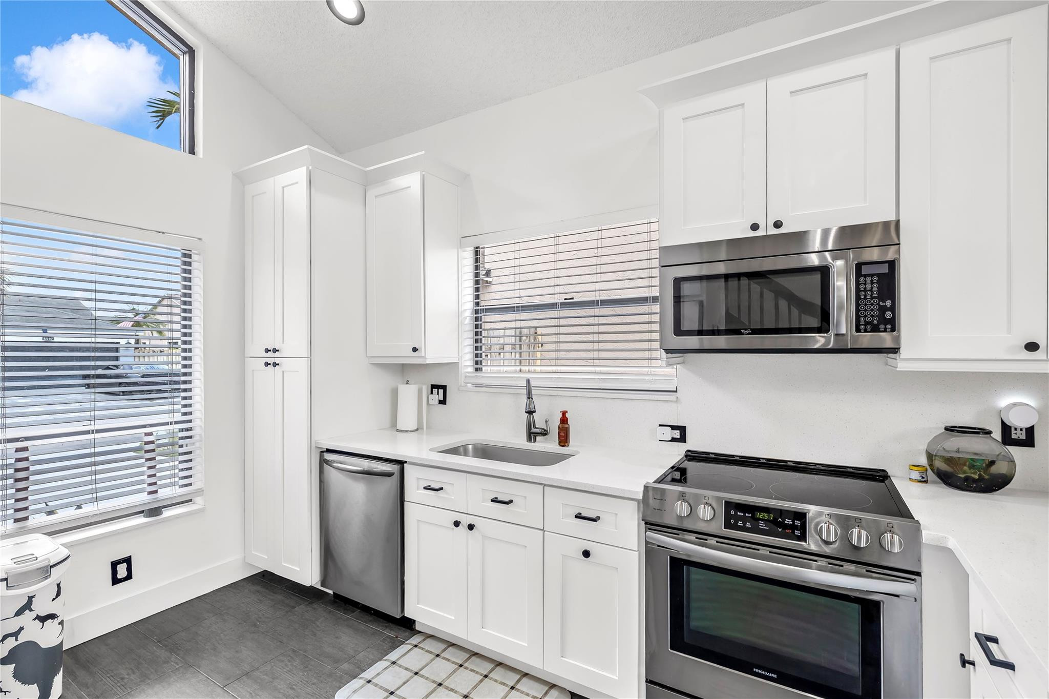 8610 Kimble Way Boca Raton, FL 33433 - Photo 8 of 26 a kitchen with stainless steel appliances a stove a sink and a microwave