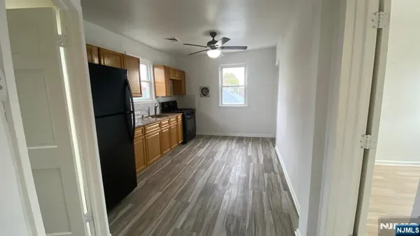 a view of a kitchen from a hallway