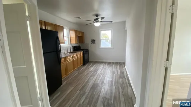a view of a kitchen from a hallway