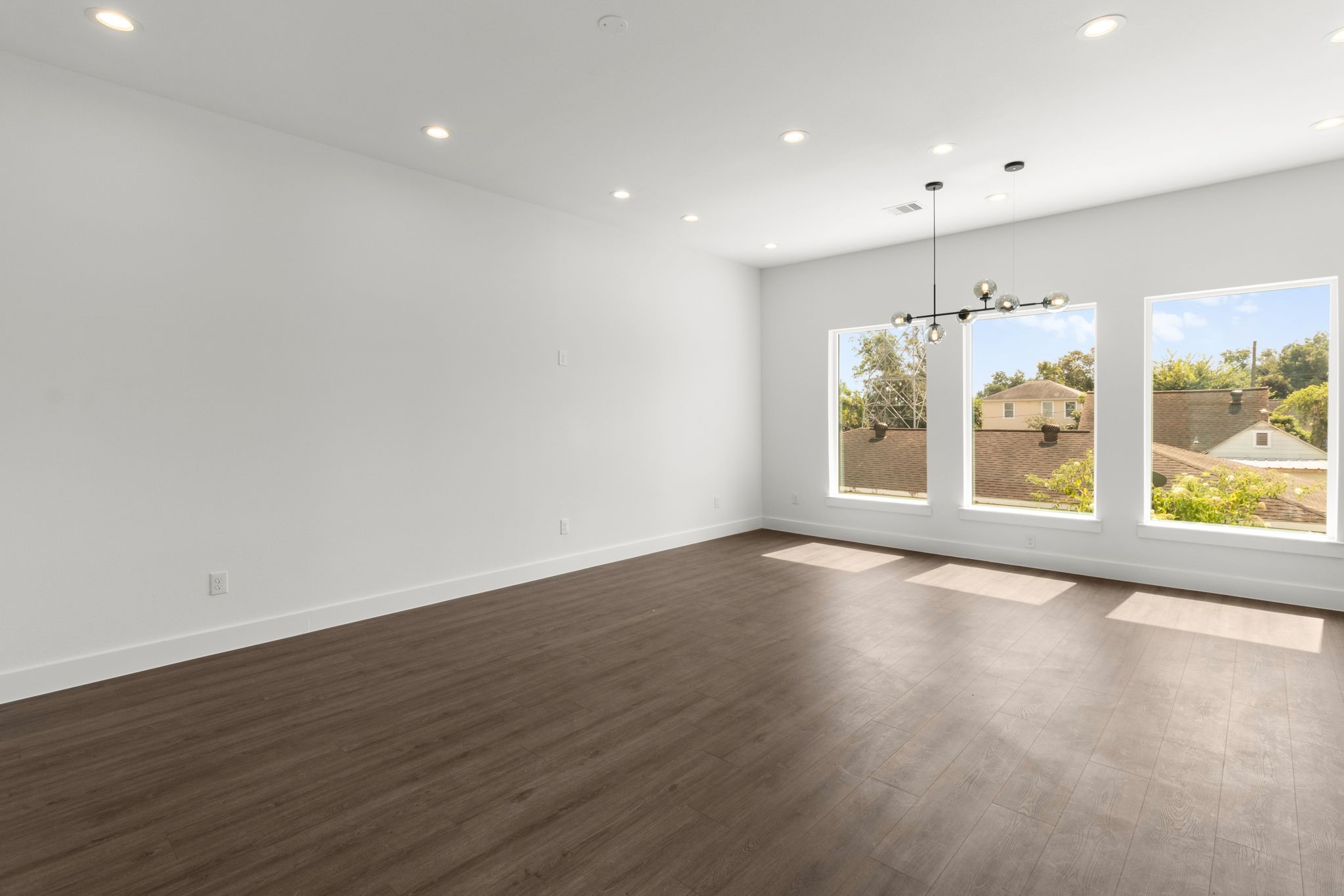 5512 Hardy Street Houston, TX 77009 - Photo 15 of 39 a view of an empty room with a window and wooden floor