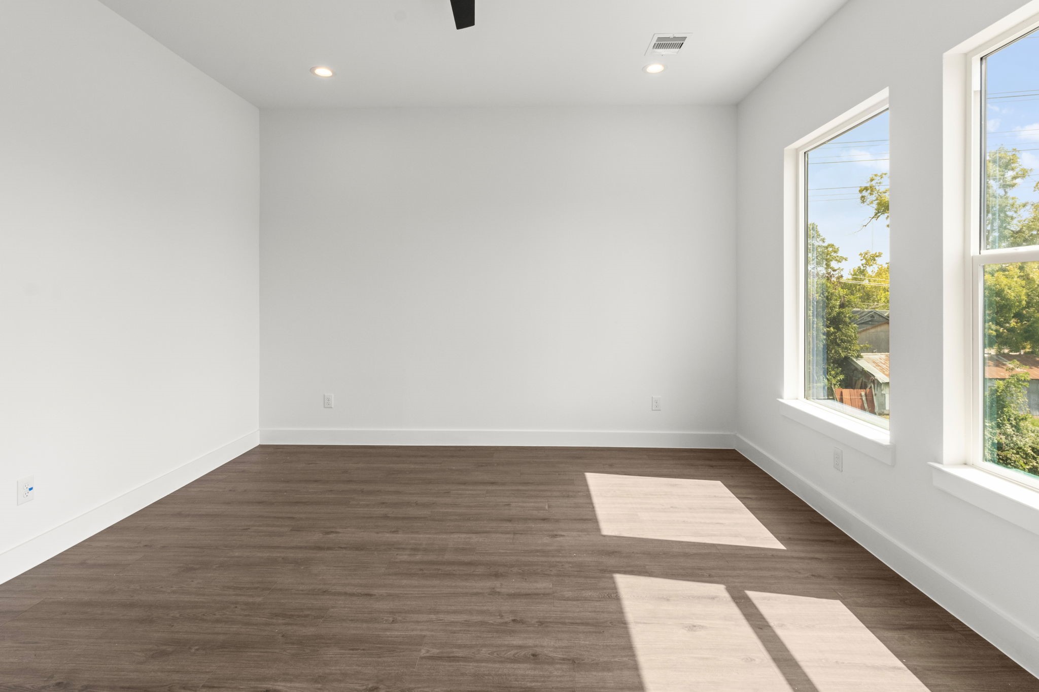 5512 Hardy Street Houston, TX 77009 - Photo 19 of 39 an empty room with wooden floor and windows