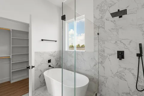 a bathroom with a bathtub and shower