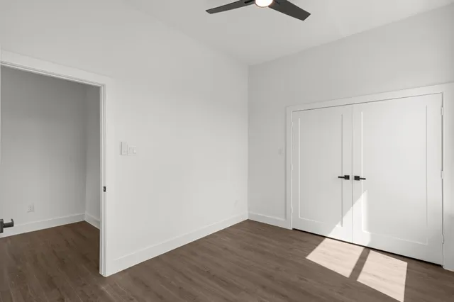 an empty room with wooden floor