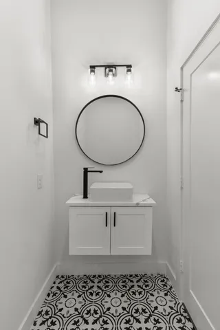 a bathroom with a sink toilet and a mirror