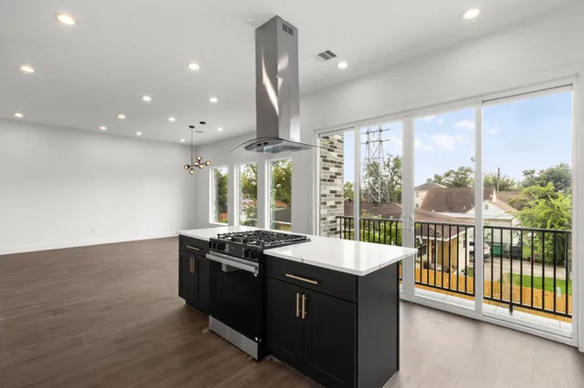 a kitchen with stainless steel appliances granite countertop a stove and a sink