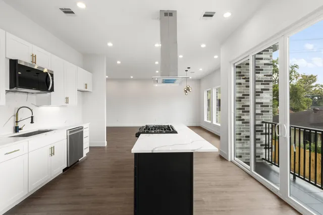 a kitchen with a sink and a stove top oven