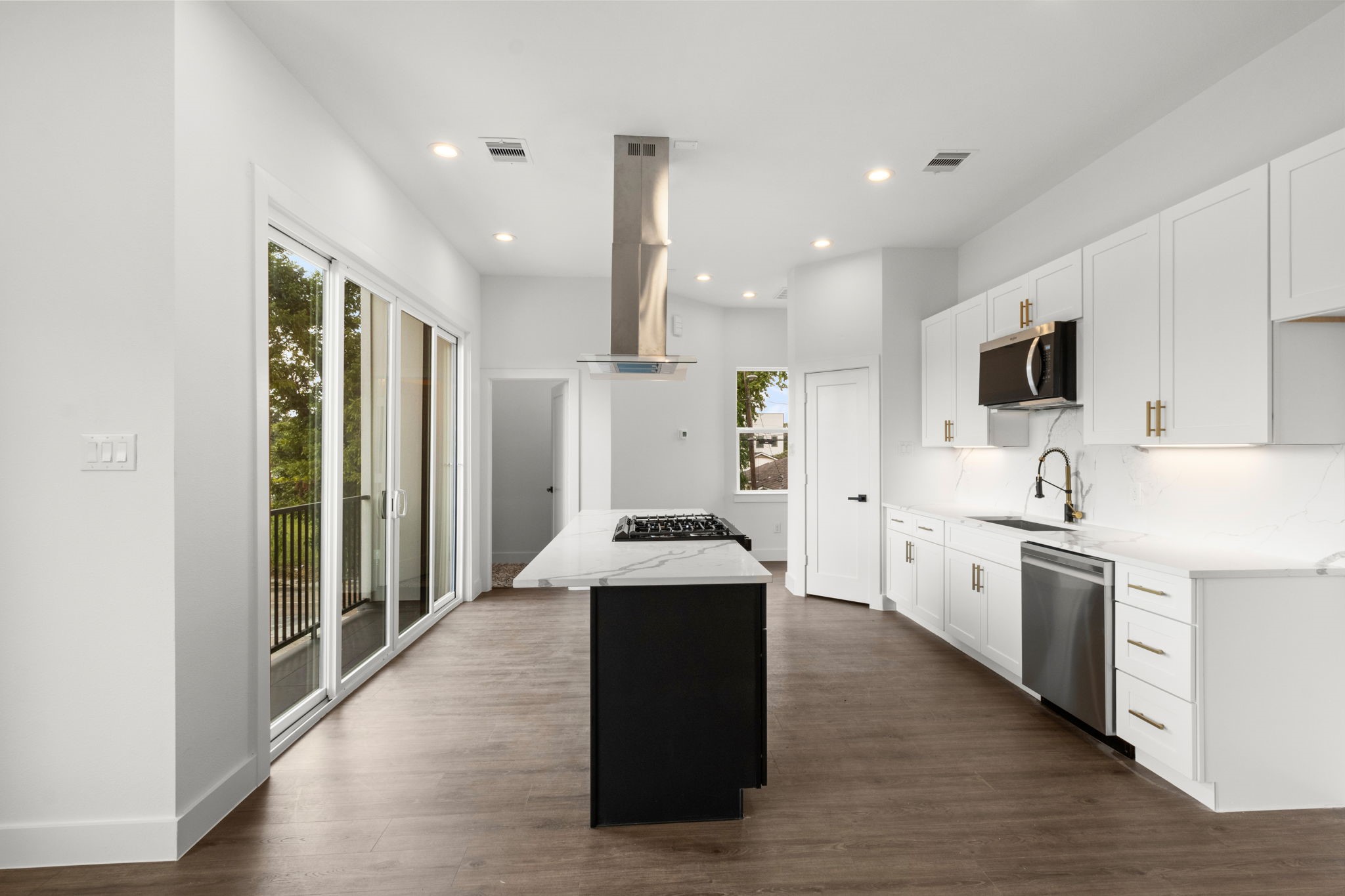5512 Hardy Street Houston, TX 77009 - Photo 8 of 39 a kitchen with stainless steel appliances kitchen island granite countertop a stove a sink and a refrigerator