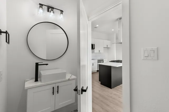 a view of a bathroom with a sink and a mirror