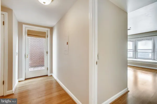 a view of a hallway with wooden floor