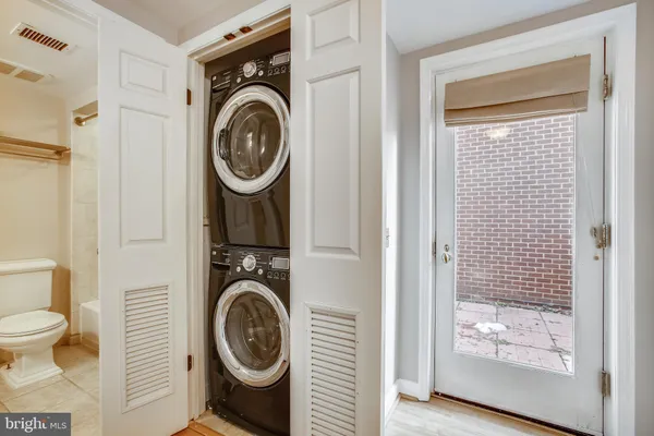 a utility room with sink dryer and washer