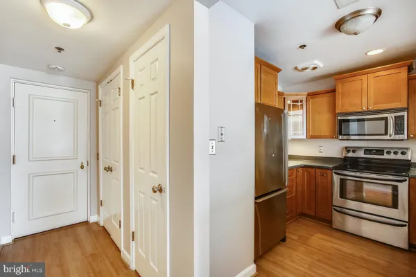 a kitchen with stainless steel appliances granite countertop a refrigerator and a stove