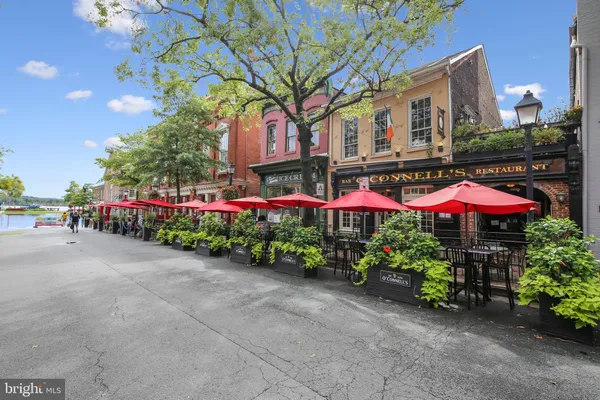 a view of a street with potted plants